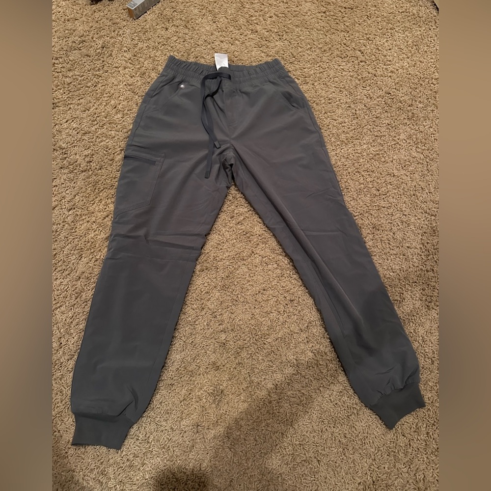 Size small jogger scuba - has more of a sweatsuit feel with the mesh. Grey